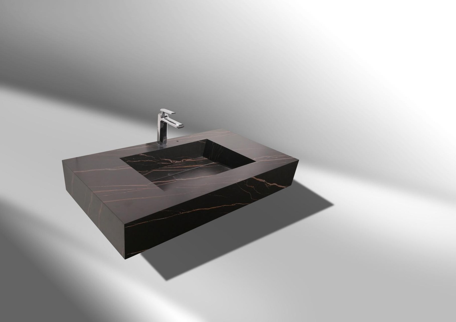 Lavabo integral de piedra sinterizada en tono marrón con vetas cobrizas y grifo cromado sobre fondo neutro